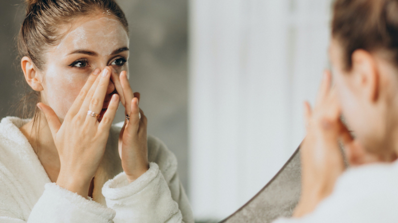 Woman at home applying cream mask