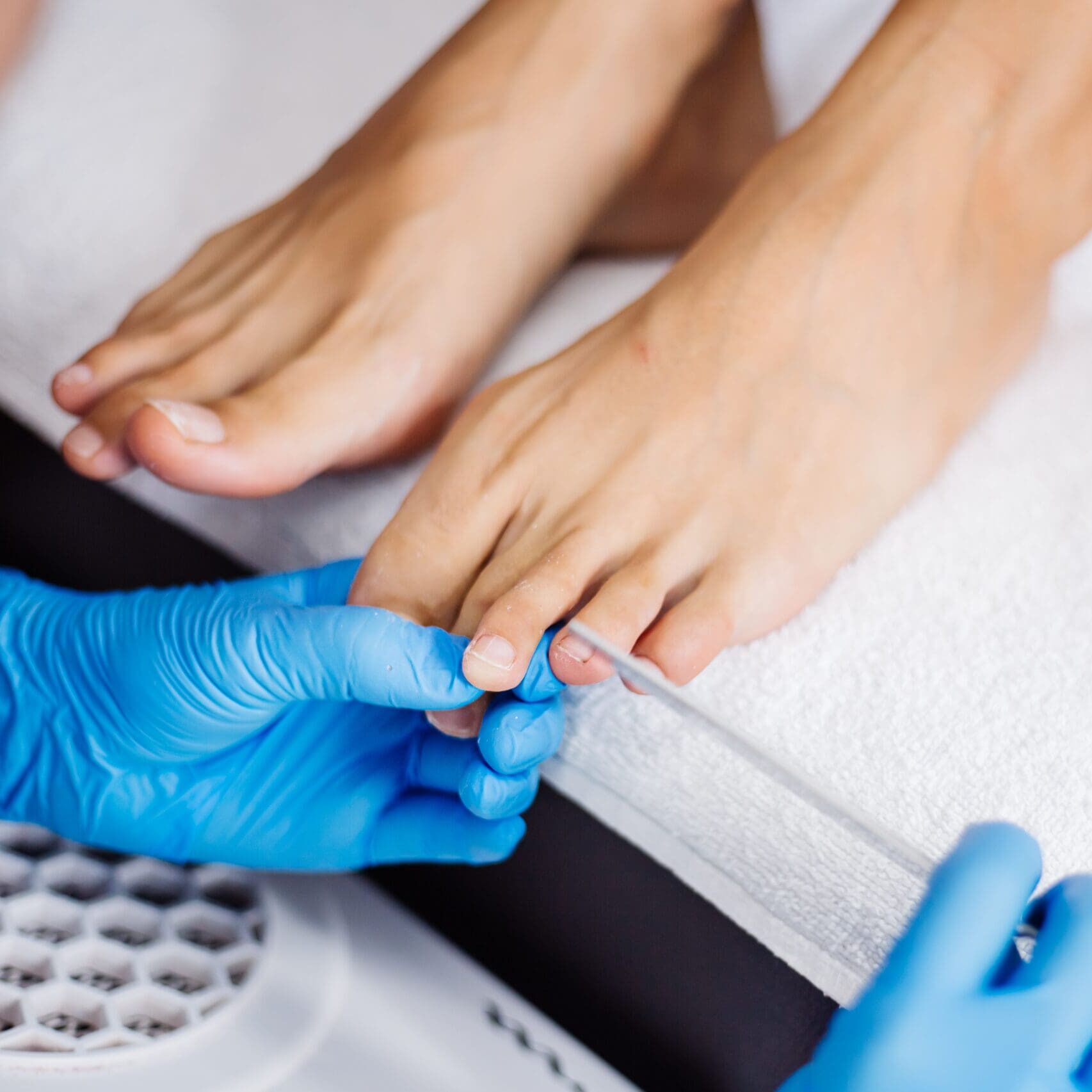 pedicure-process-home-salon-pedicure-foot-care-treatment-nail-process-professional-pedicures-master-blue-gloves-make-pedicure